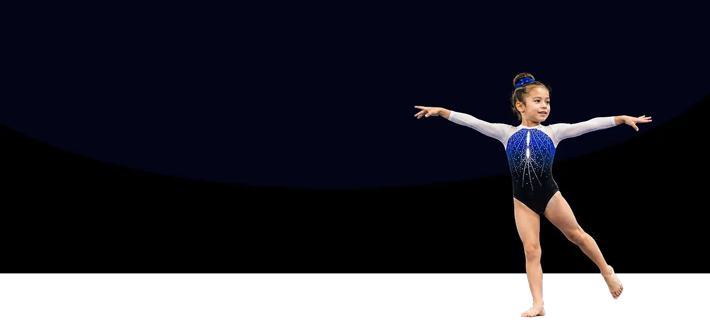 A young PEGA gymnast in a blue team leotard, arms out after a routine